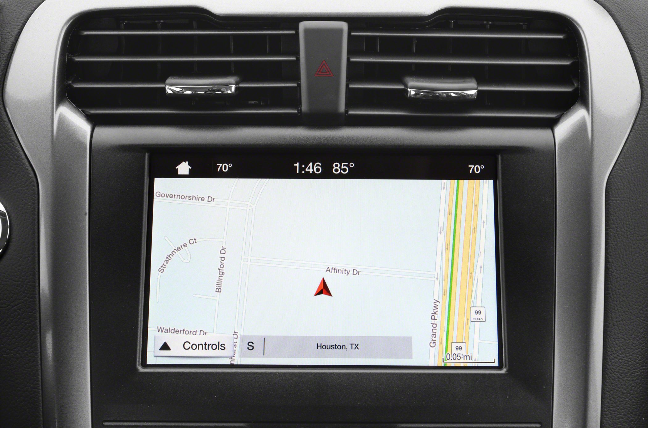 GPS navigation screen and dashboard air vents with hazard button