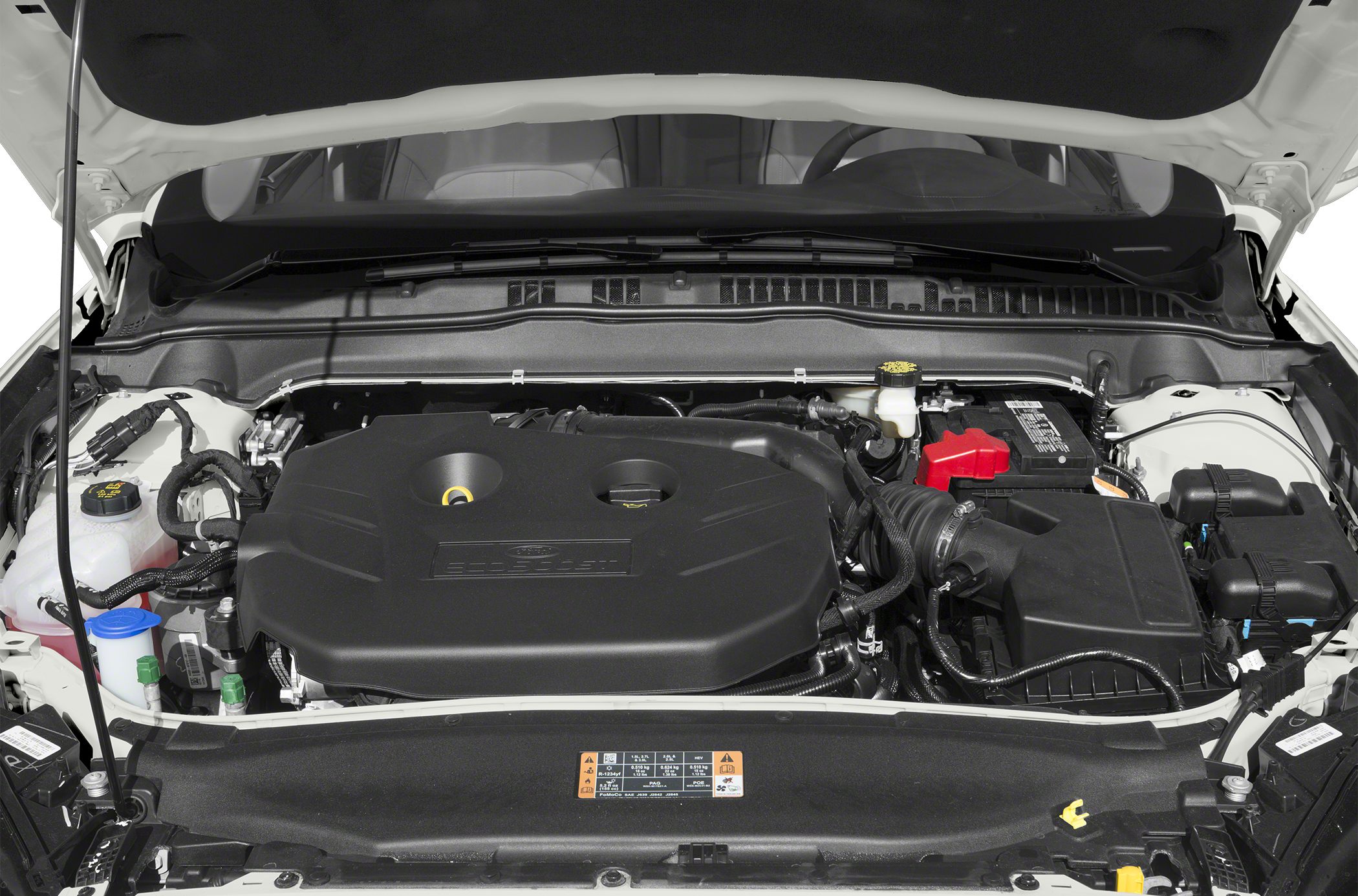 Engine bay with covered engine and visible battery in a modern sedan