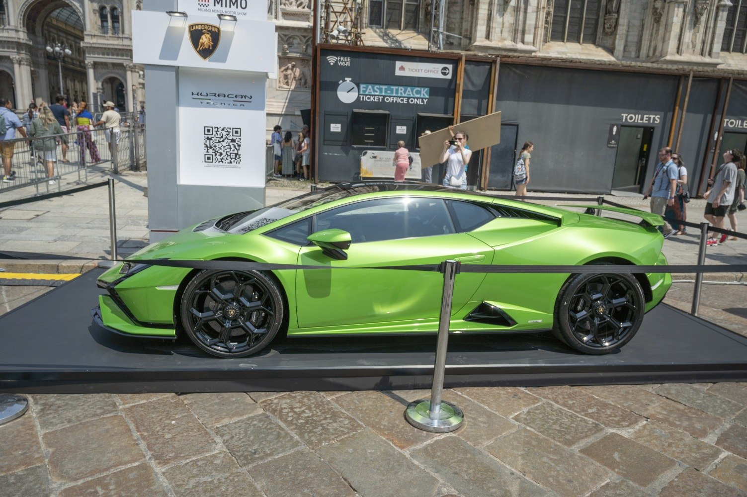 Green Lamborghini supercar side profile with black wheels