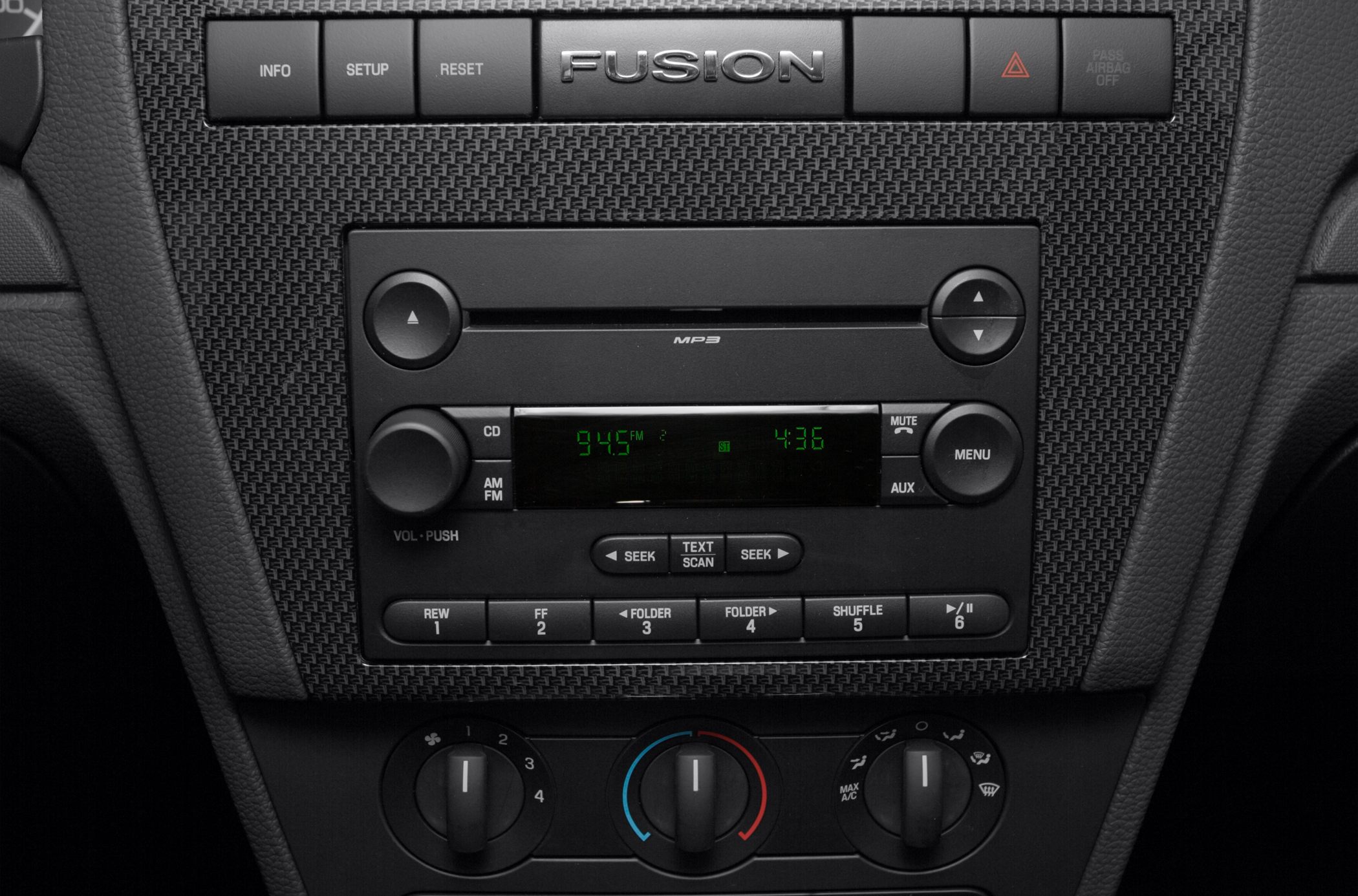 Center console audio and climate control panel with buttons and dials