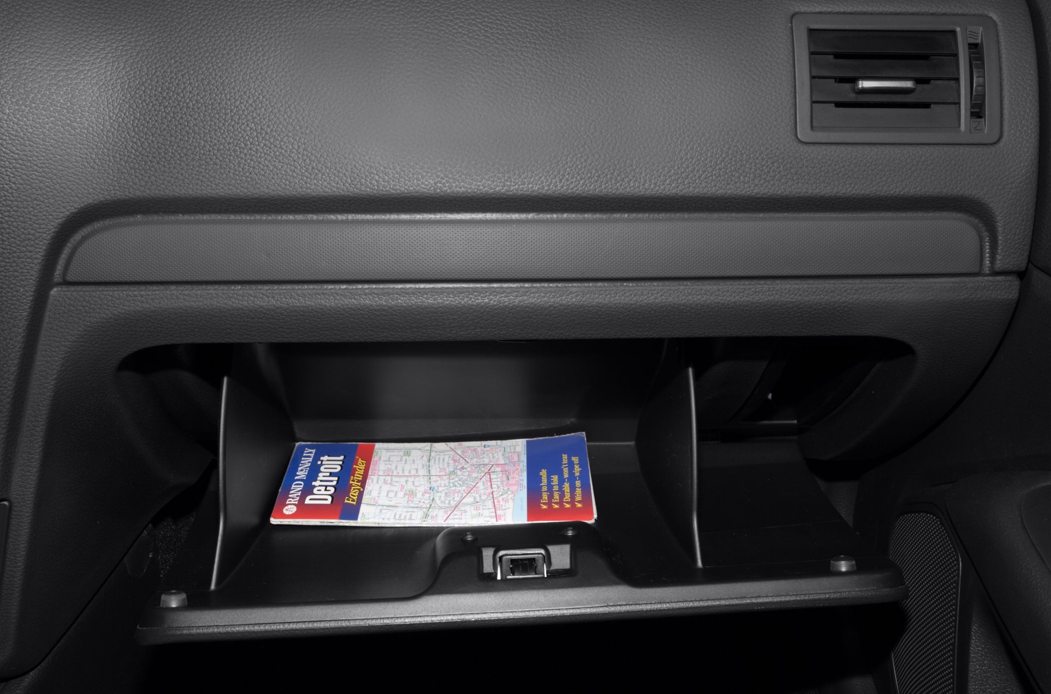 Open glovebox with internal divider and adjacent air vent