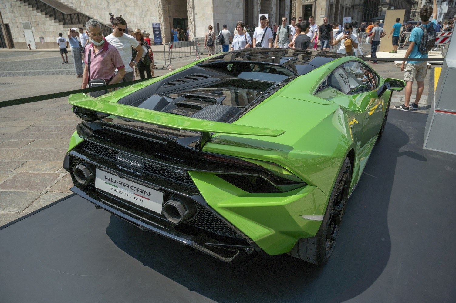 Rear view with spoiler, tail lights, engine vents, and diffuser