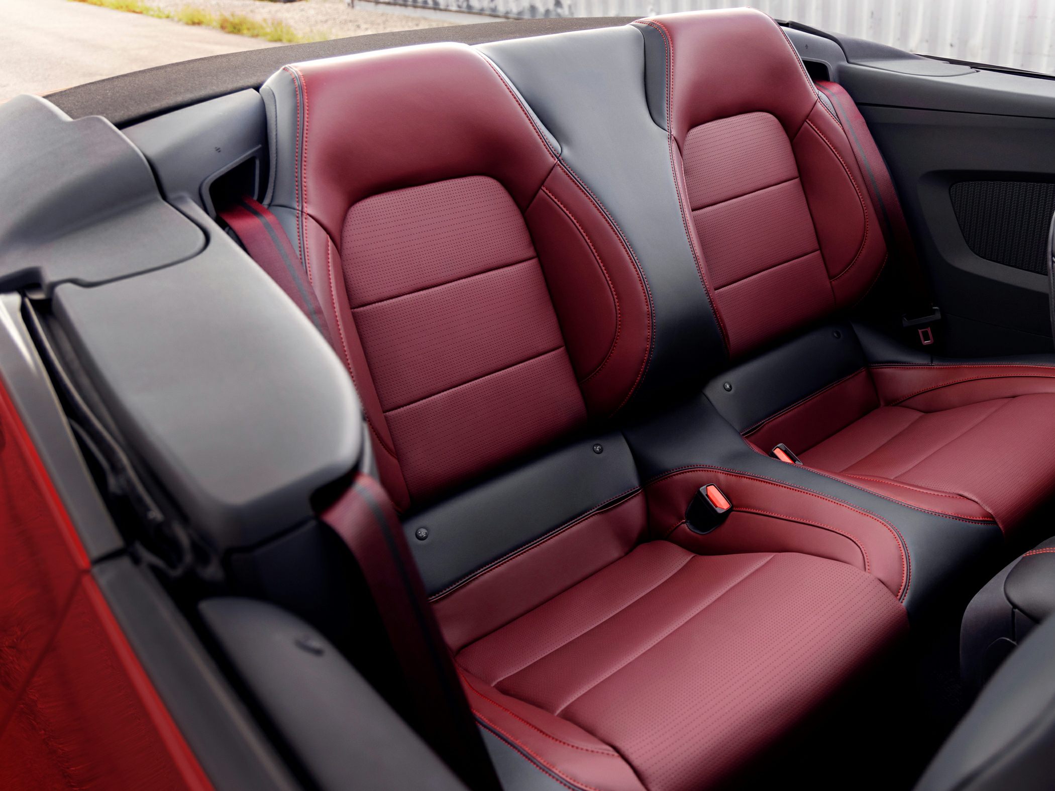 Red and black leather rear seats with detailed stitching.