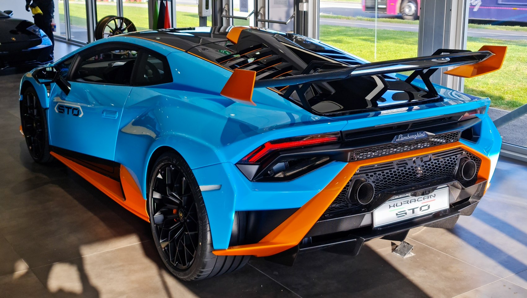 Aggressive rear wing with sporty aerodynamic design and dual exhausts.
