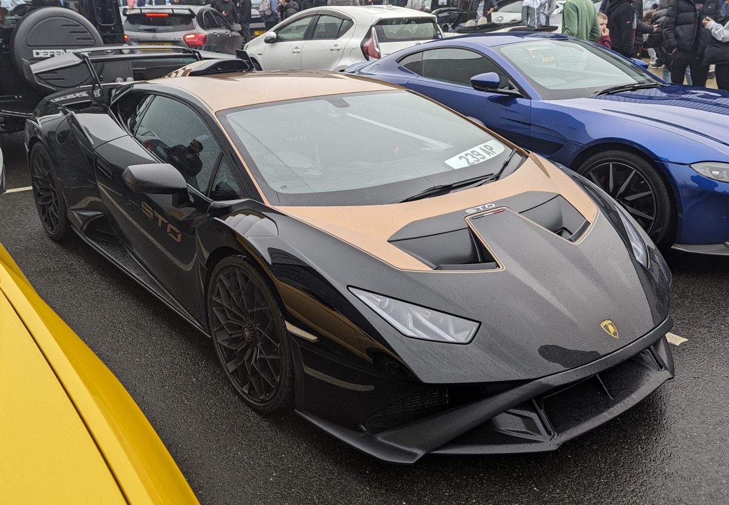 Aggressive aerodynamic front with large rear wing and sleek black-gold accents