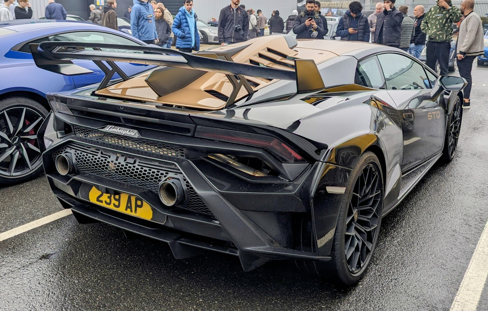 Rear view with large racing wing and aggressive exhaust design.