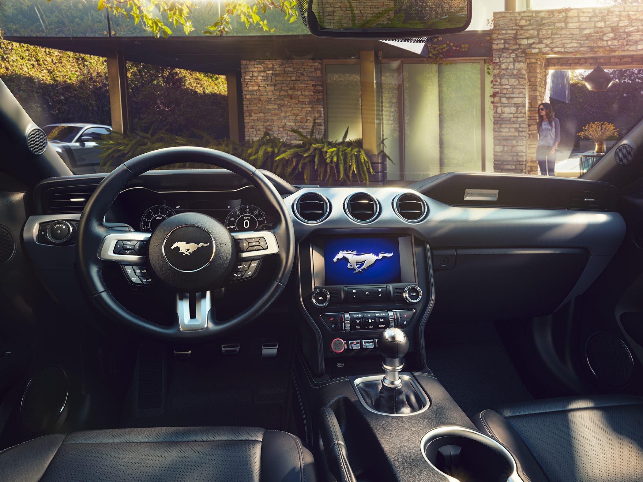 Leather-wrapped steering wheel and center console with infotainment screen