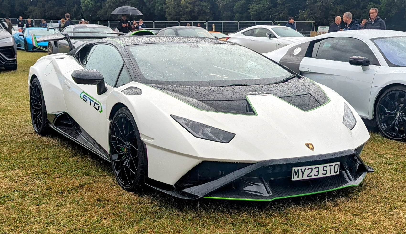 White sports coupe with carbon fiber hood and large rear wing