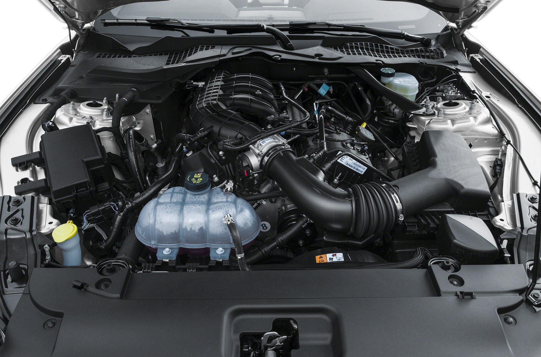 Close-up of engine bay with air intake and fluid reservoirs