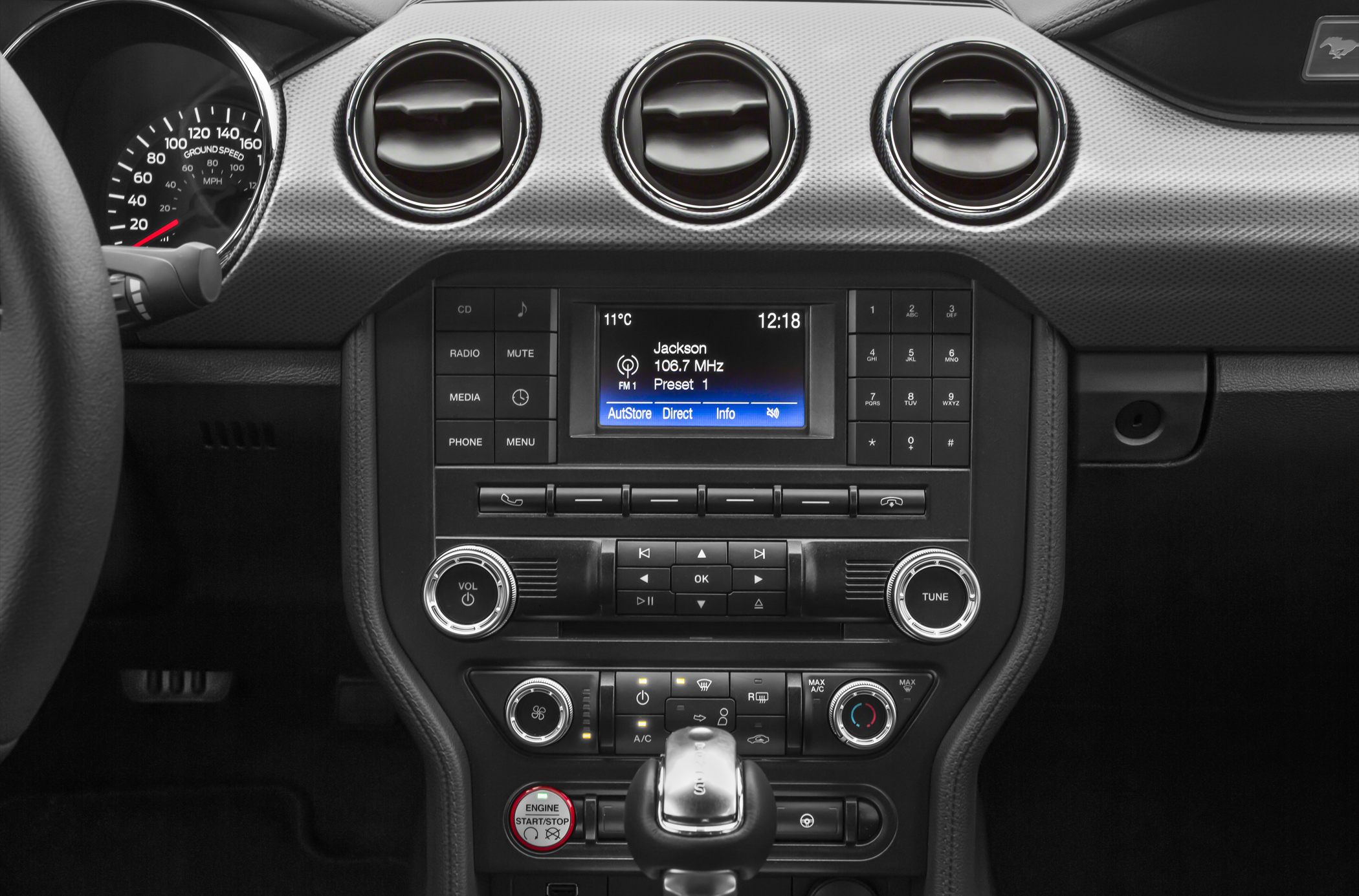Center console with infotainment, climate controls, and engine start button