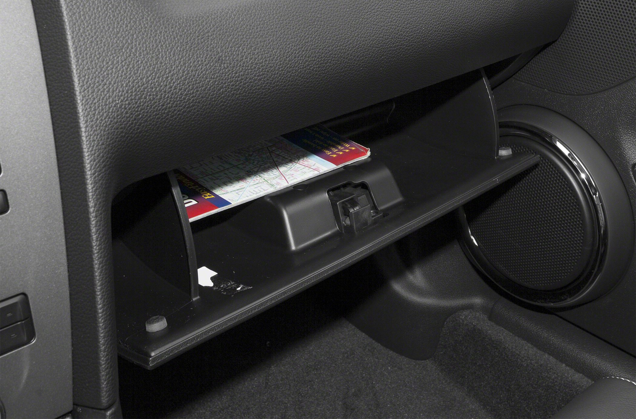 Open glove compartment and door speaker in car interior