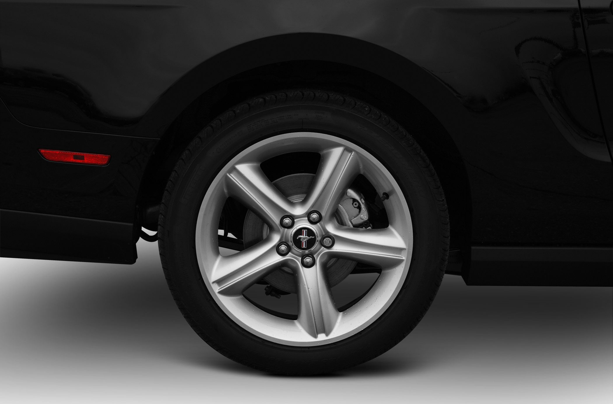 5-spoke silver alloy wheel with visible brake caliper and tire tread