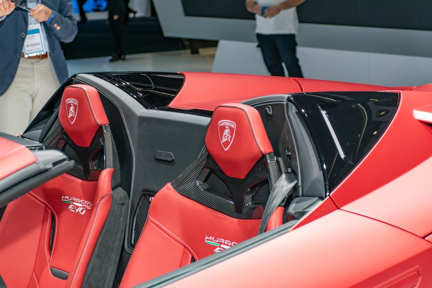 Red leather seats with carbon fiber backs and Lamborghini logo