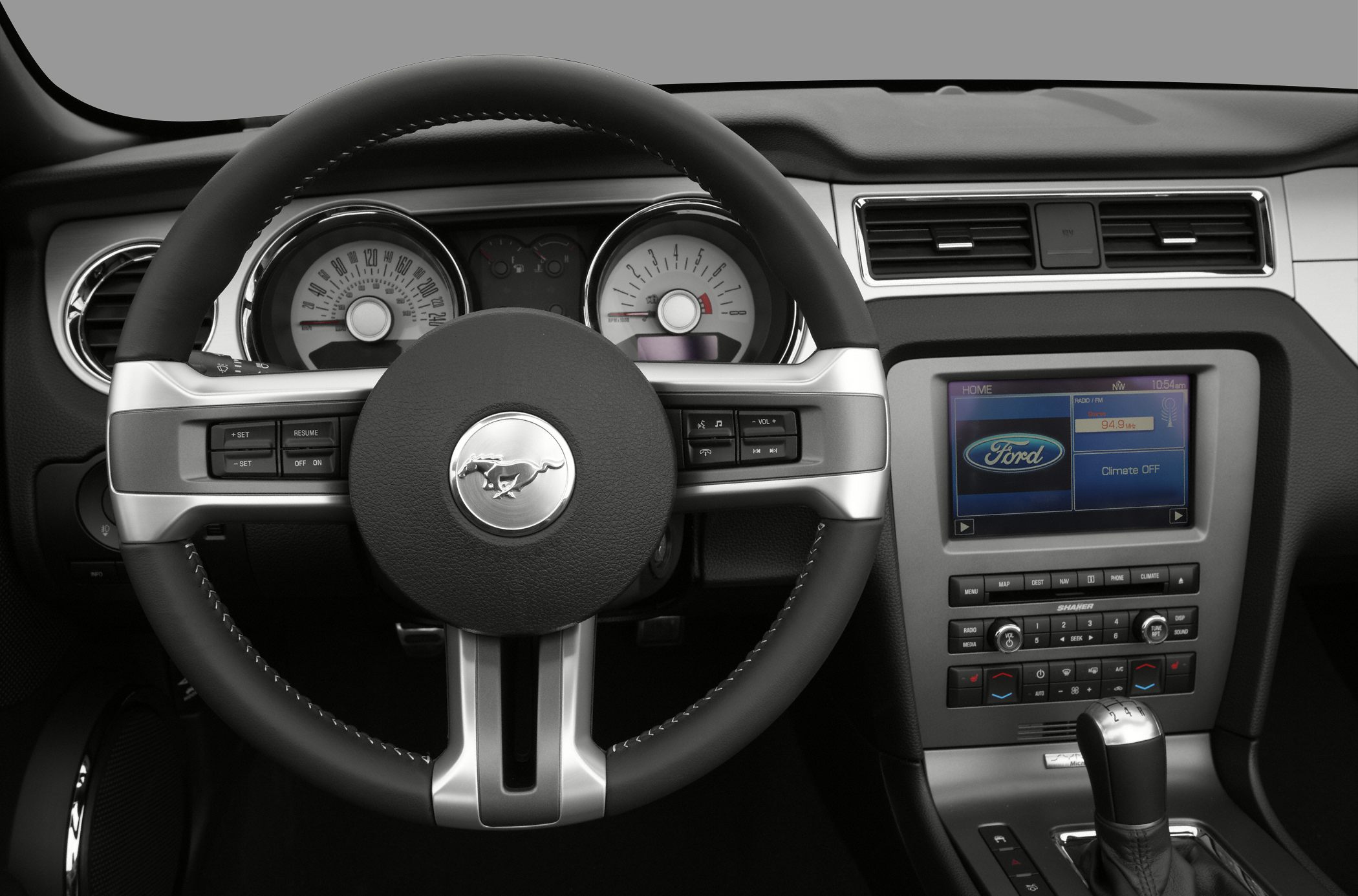 Steering wheel with Mustang emblem and dashboard with gauges and infotainment screen