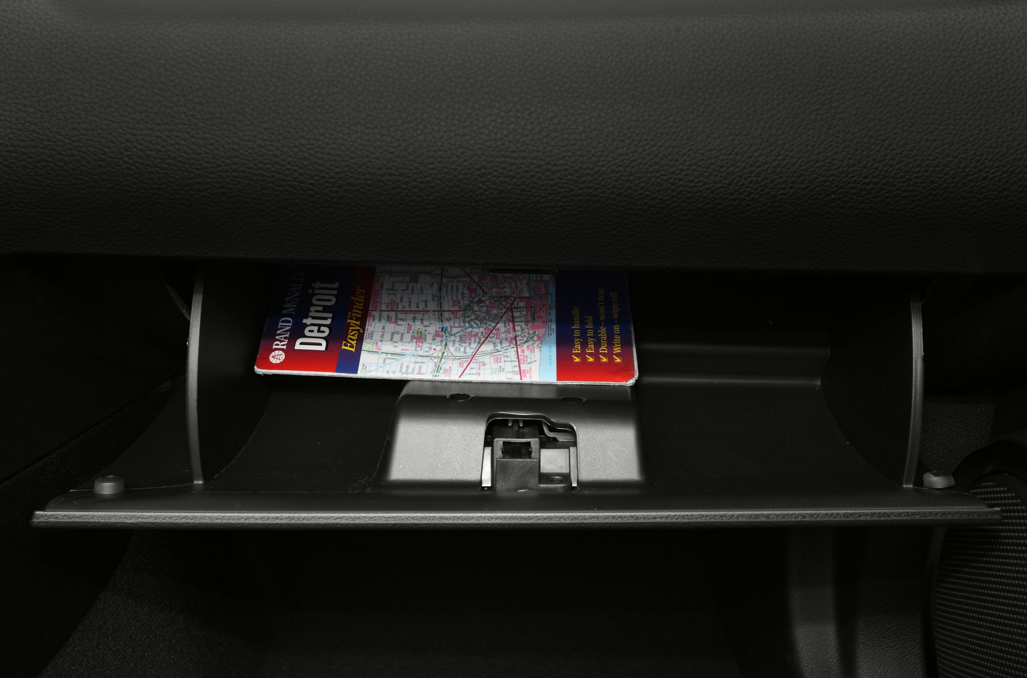 Open glove box with Detroit city map inside