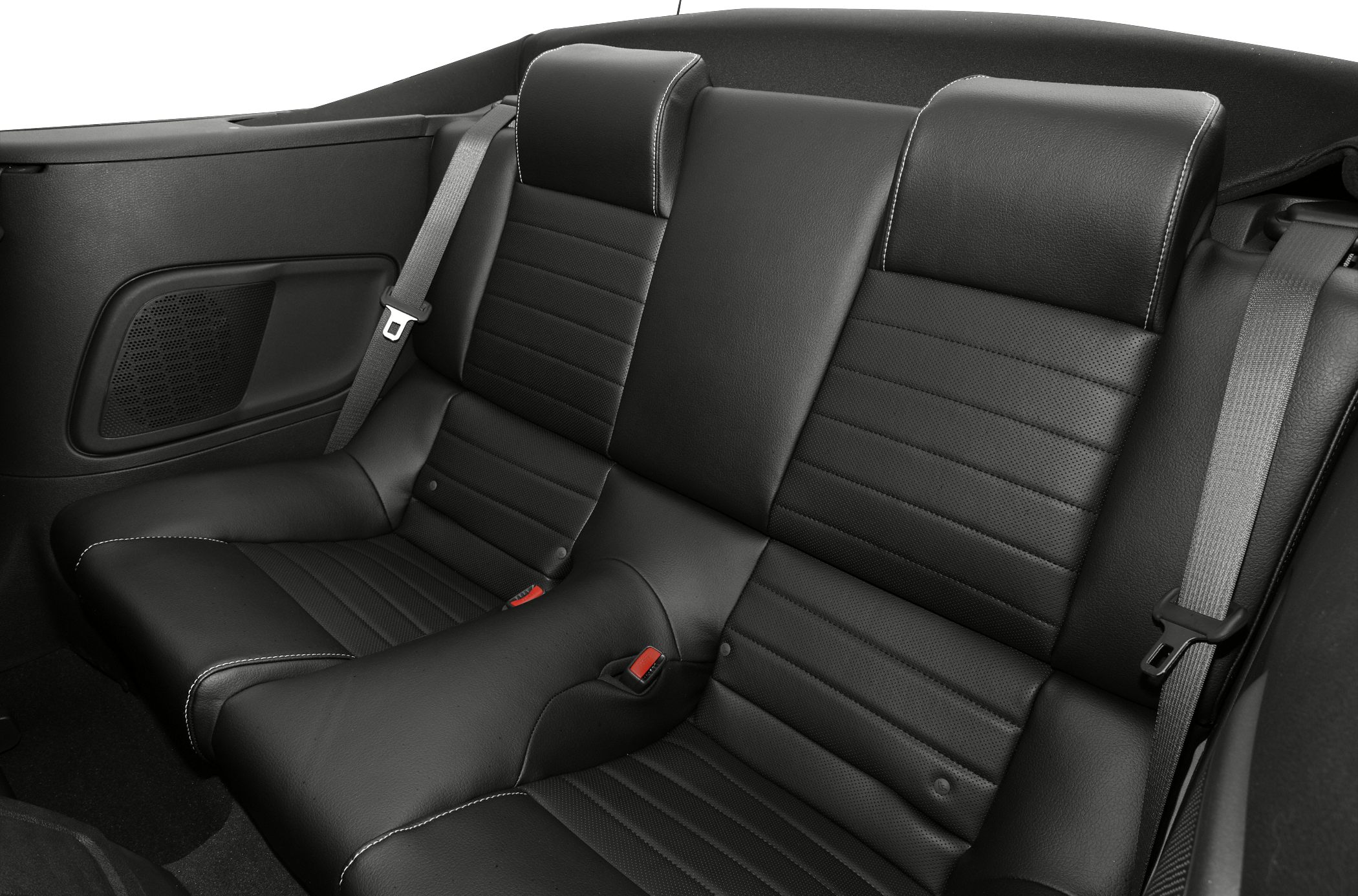 Black leather rear seats with seat belts in a convertible.