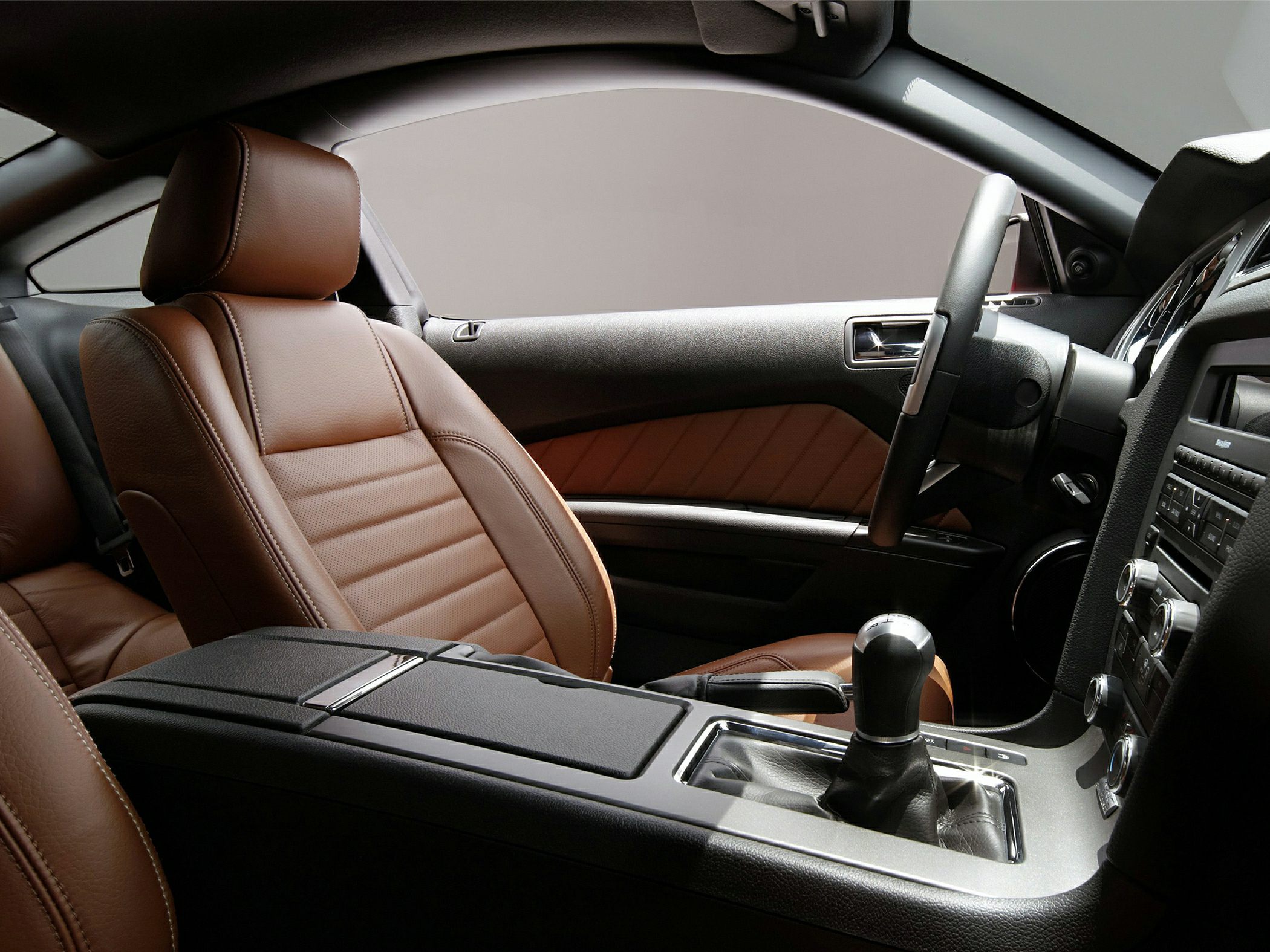 Brown leather seats and central gear shift console interior