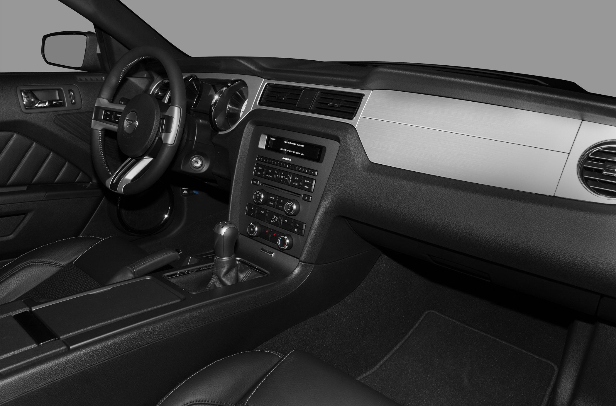 Dashboard, steering wheel, and center console with controls.