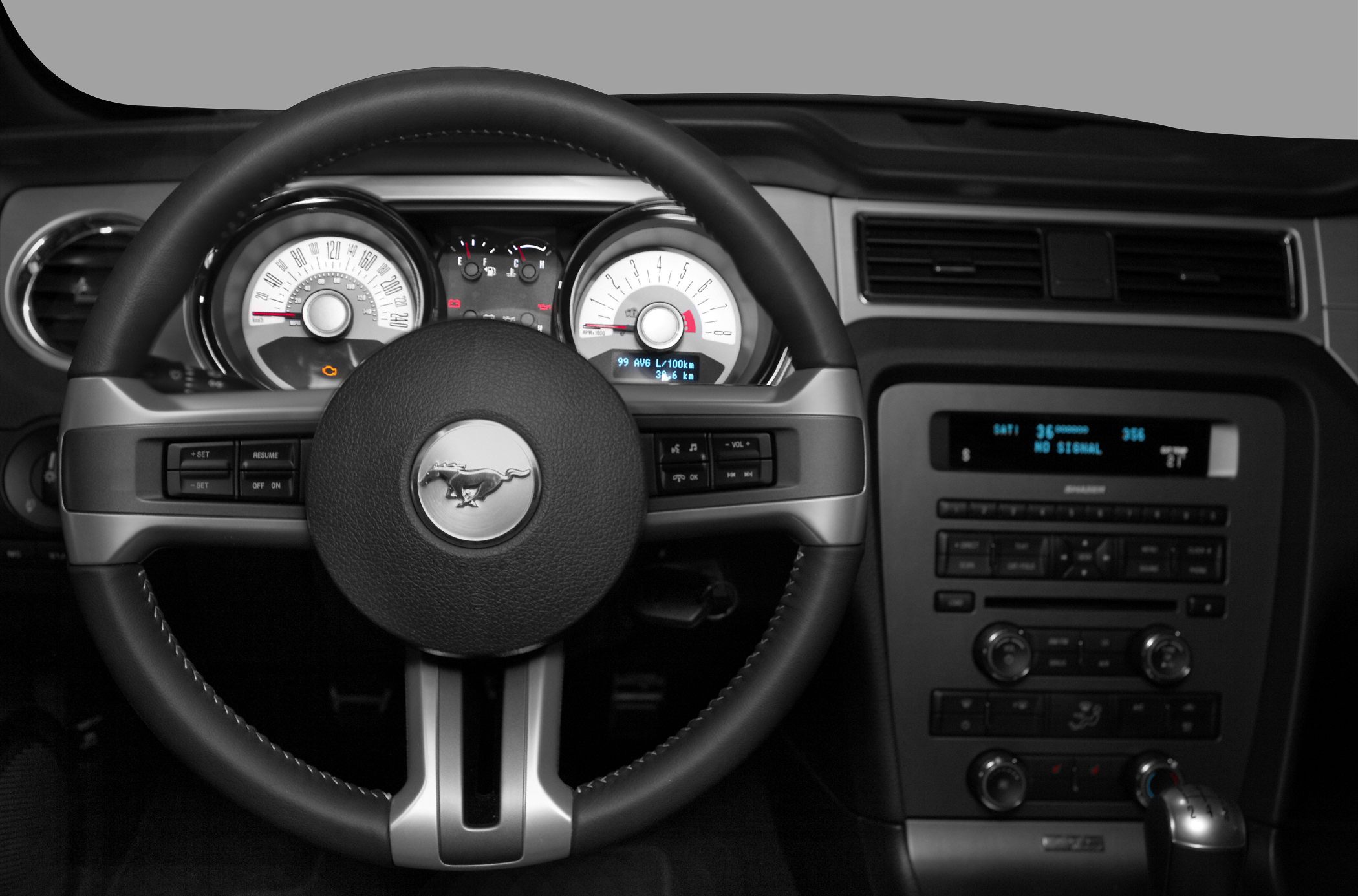 Steering wheel with Mustang emblem and detailed dashboard gauges.