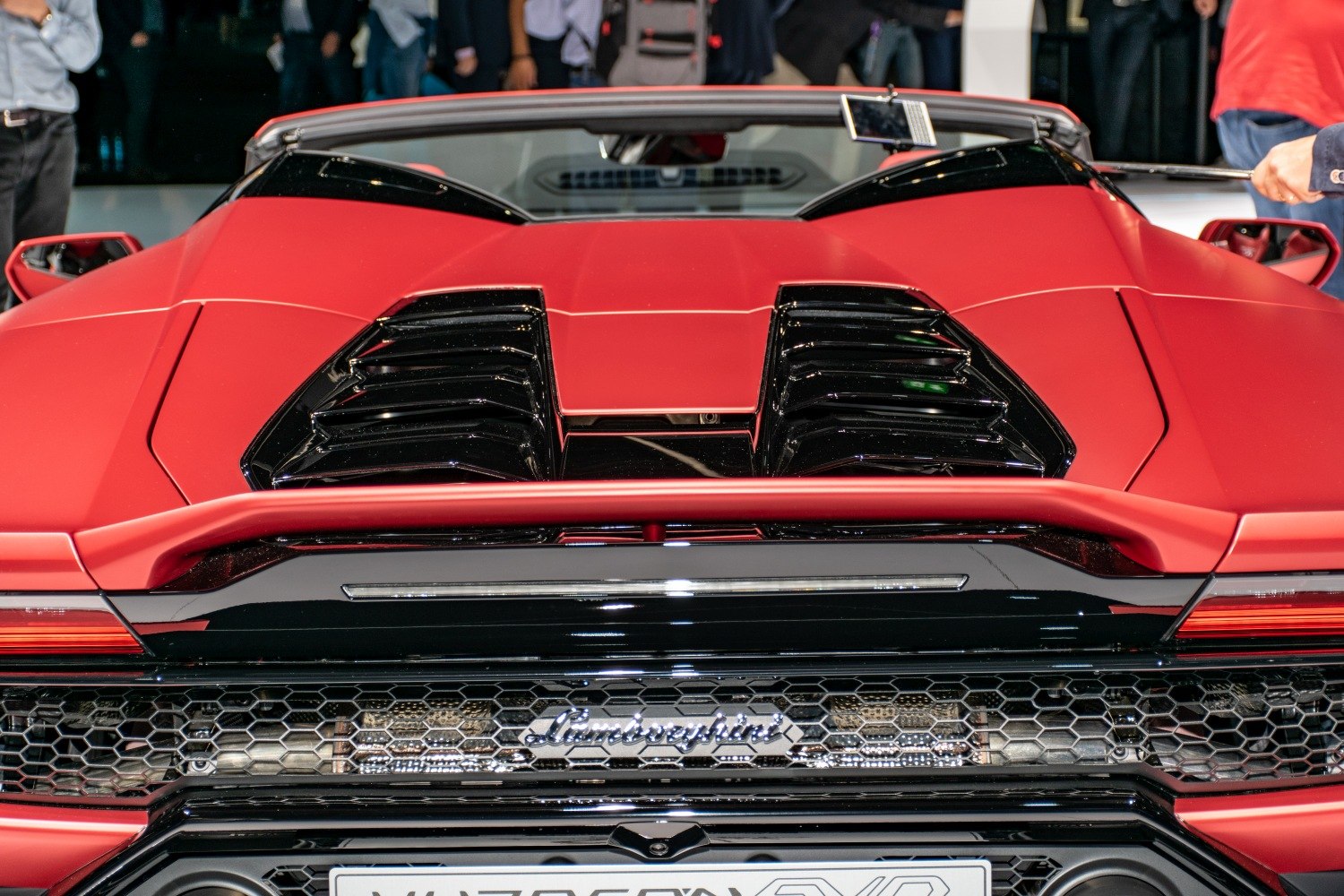 Rear engine deck with black ventilation grills on a red sports convertible