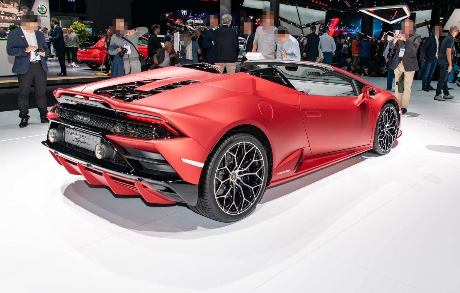 Red convertible sports car with aggressive rear design and intricate wheel pattern