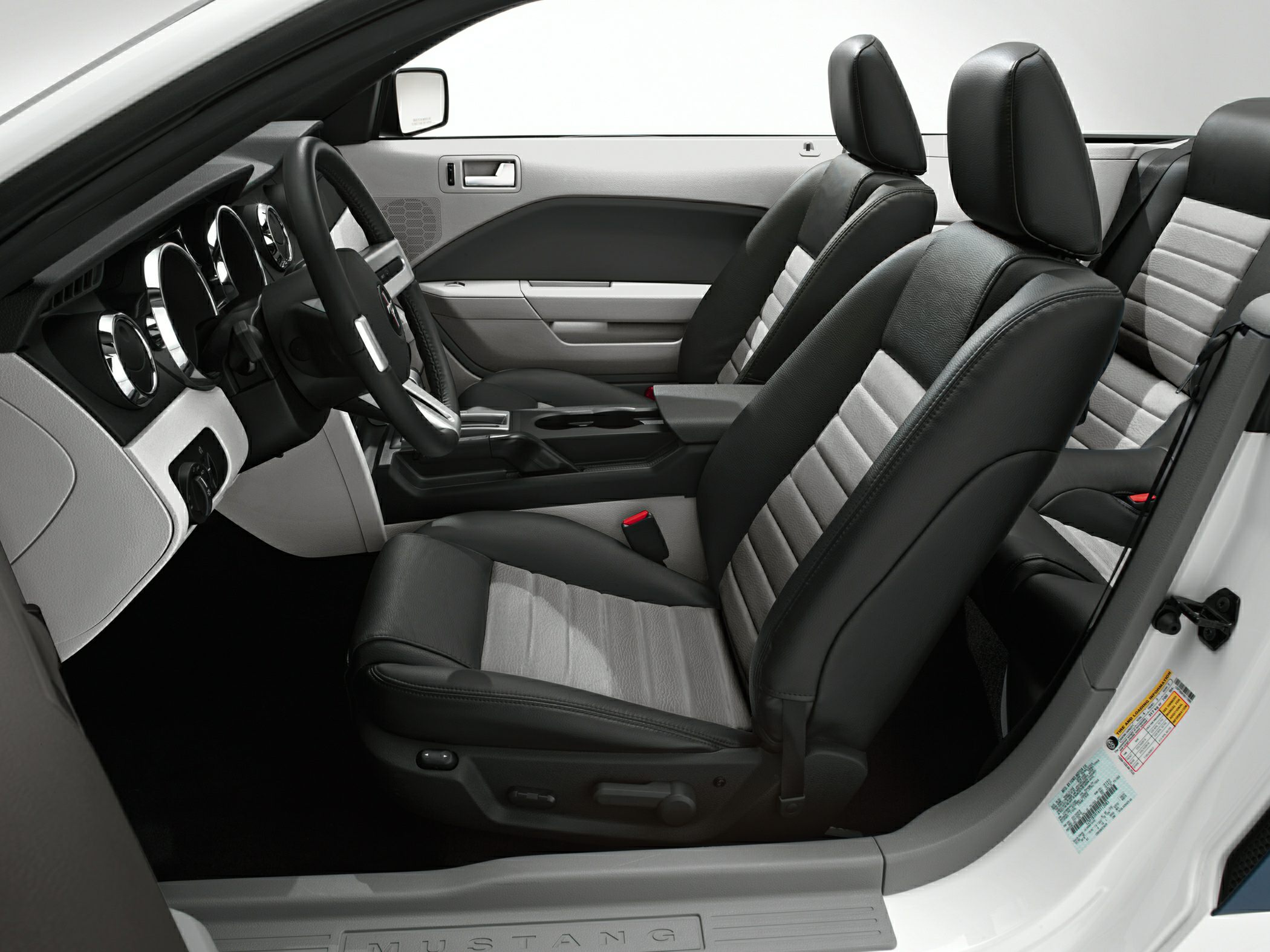 Black and gray leather seats with modern dashboard and seat controls.