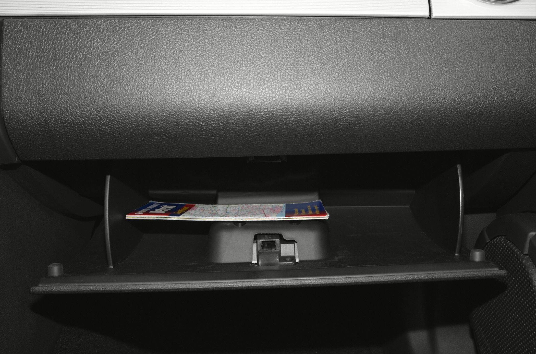 Interior glove box compartment with a folded map inside