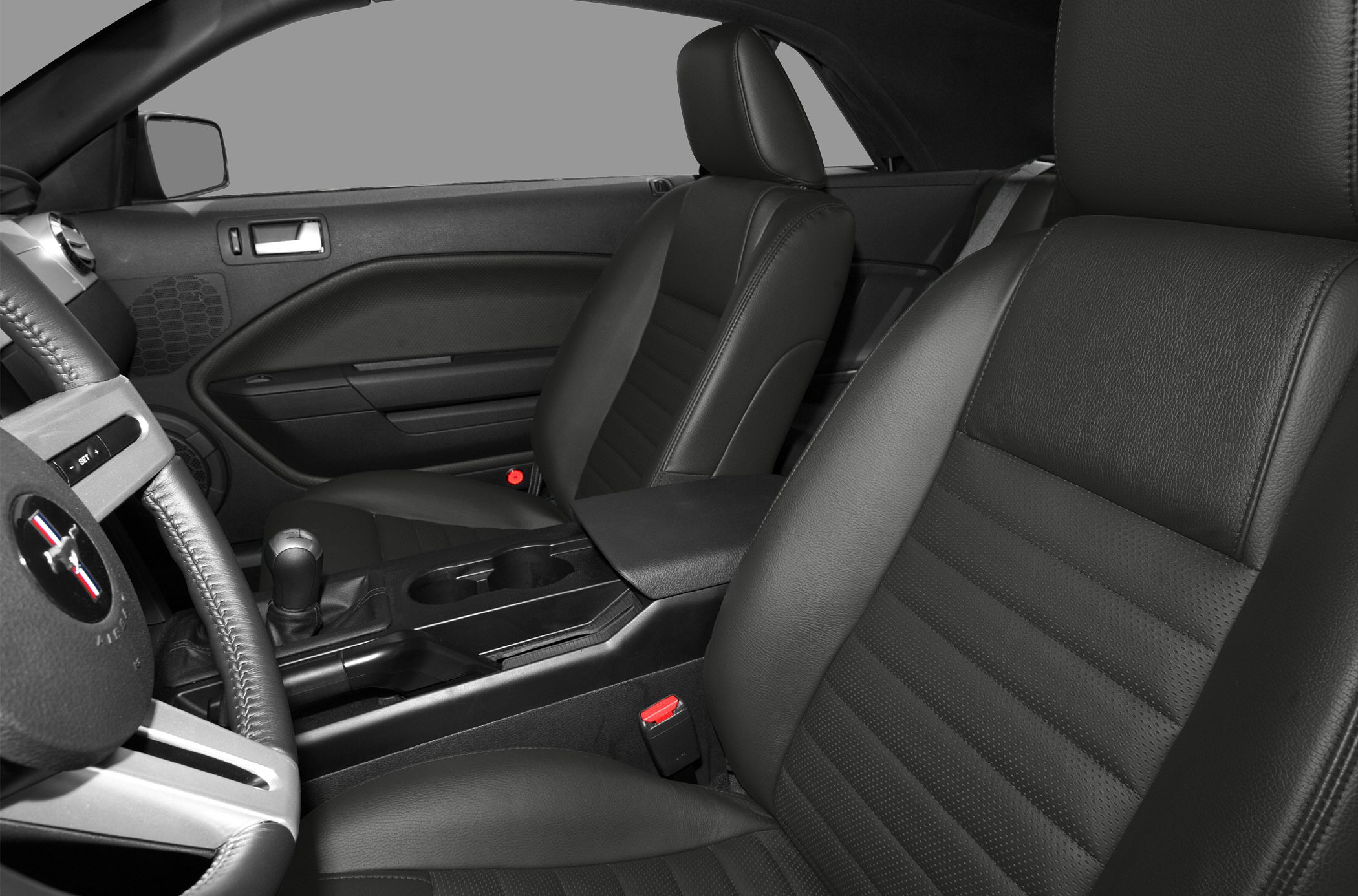 Black leather seats and center console interior with manual gear shift