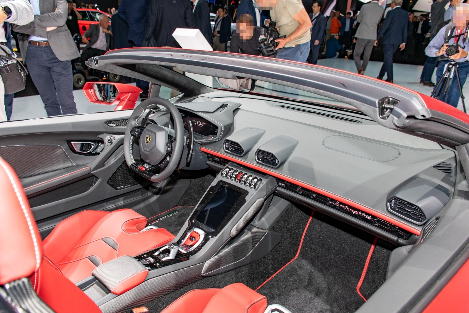Red and black luxury sports car interior with digital dashboard and advanced controls