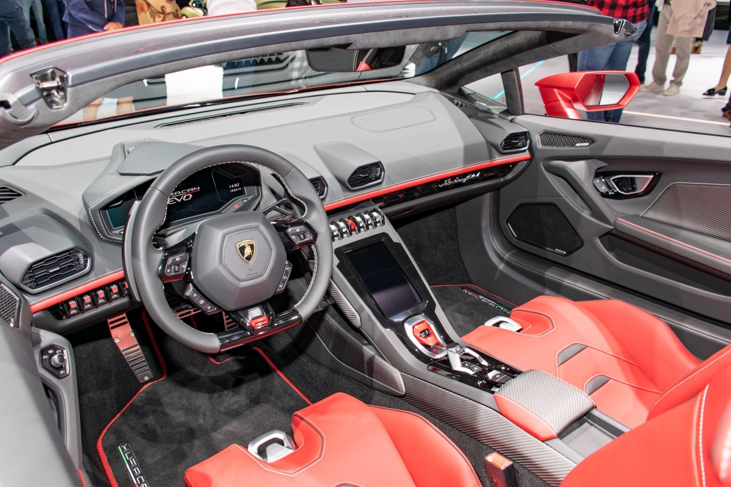 Luxury sports car interior with advanced dashboard and red leather seats