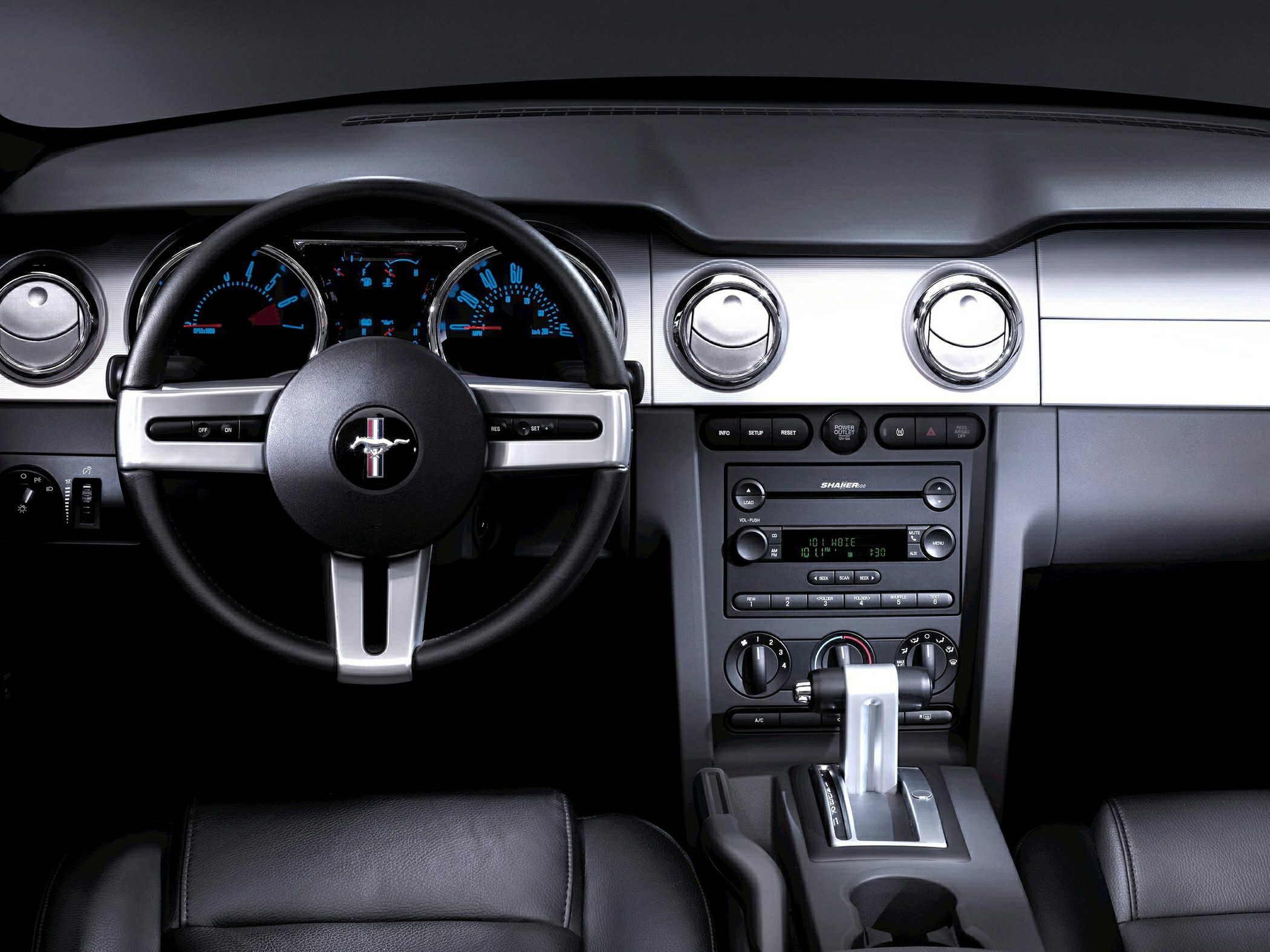 Classic steering wheel and dashboard with gauges and center console controls