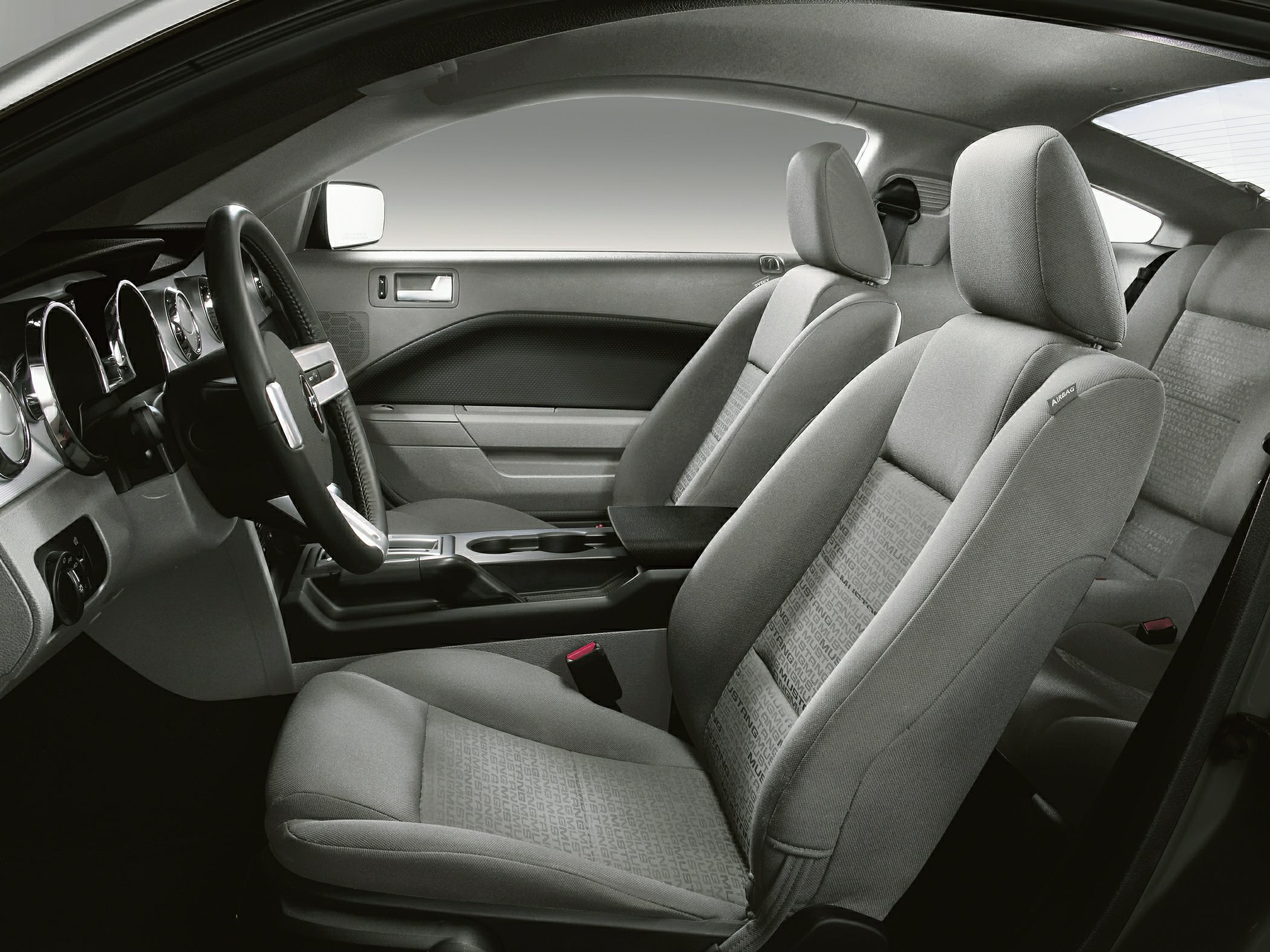 Front fabric seats and dashboard with steering wheel