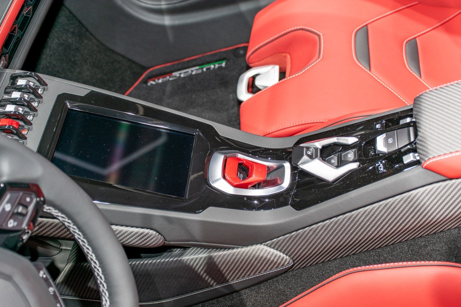 Center console with carbon fiber trim and red ignition start button