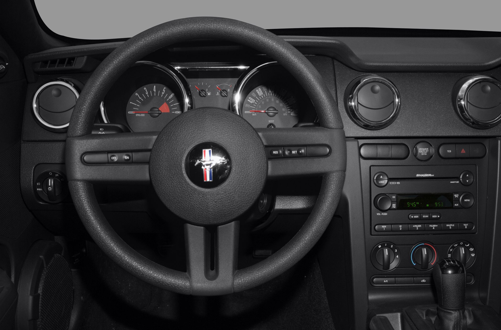 Steering wheel and dashboard with instrument cluster and center console controls