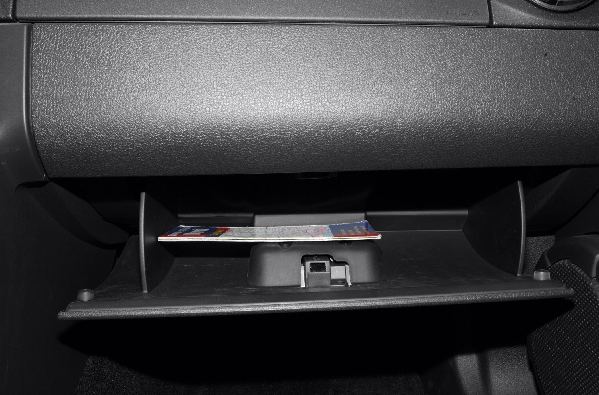 Open glove compartment with visible dashboard storage space.