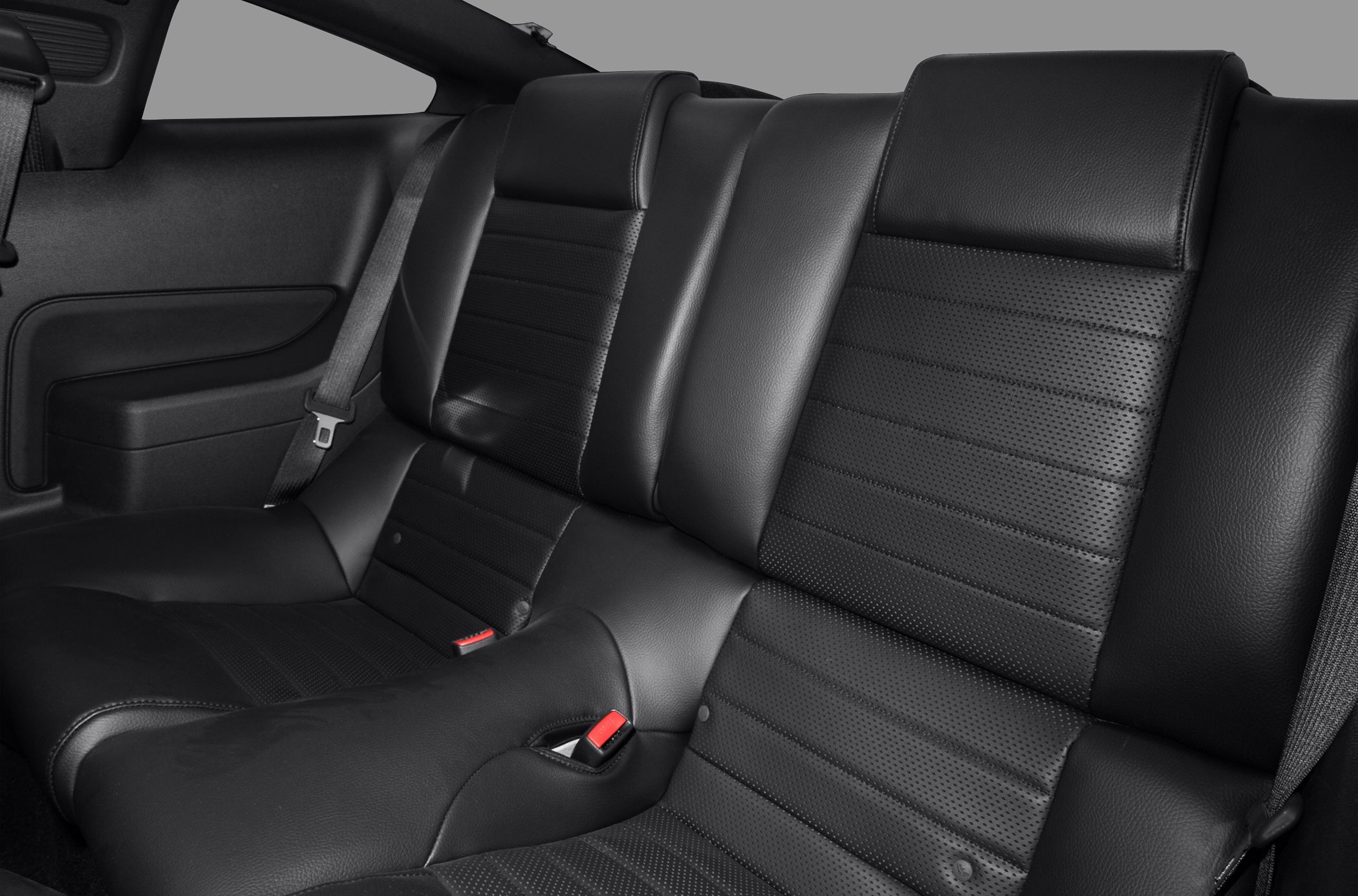 Black leather rear seats with seat belts and detailed stitching