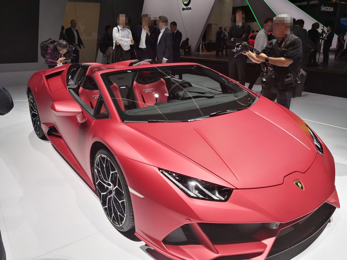 Red matte finish convertible with aerodynamic design and intricate wheel pattern