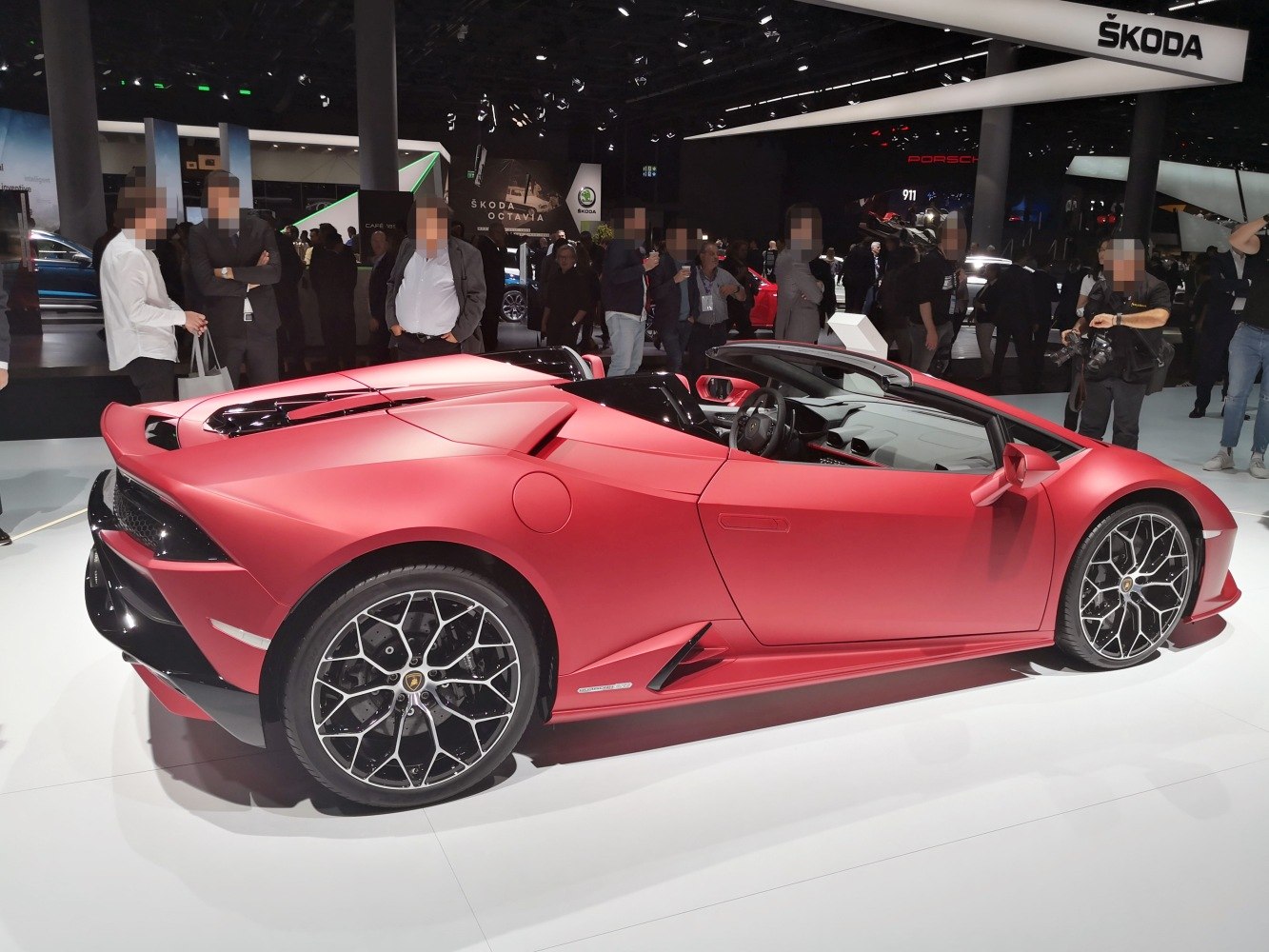 Red convertible sports car with aerodynamic design and unique alloy wheels.