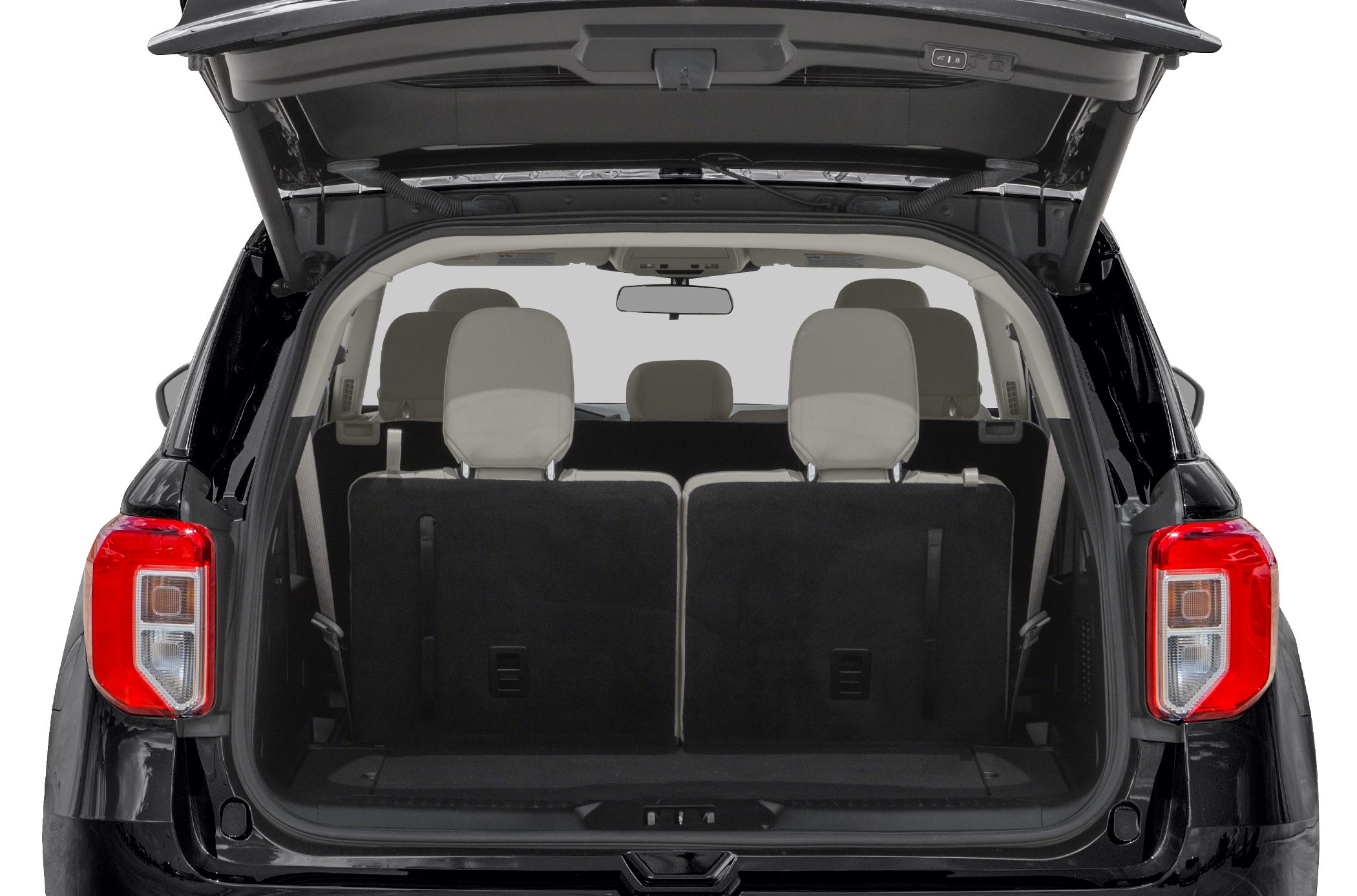 SUV rear cargo area with rear seats upright and headrests.
