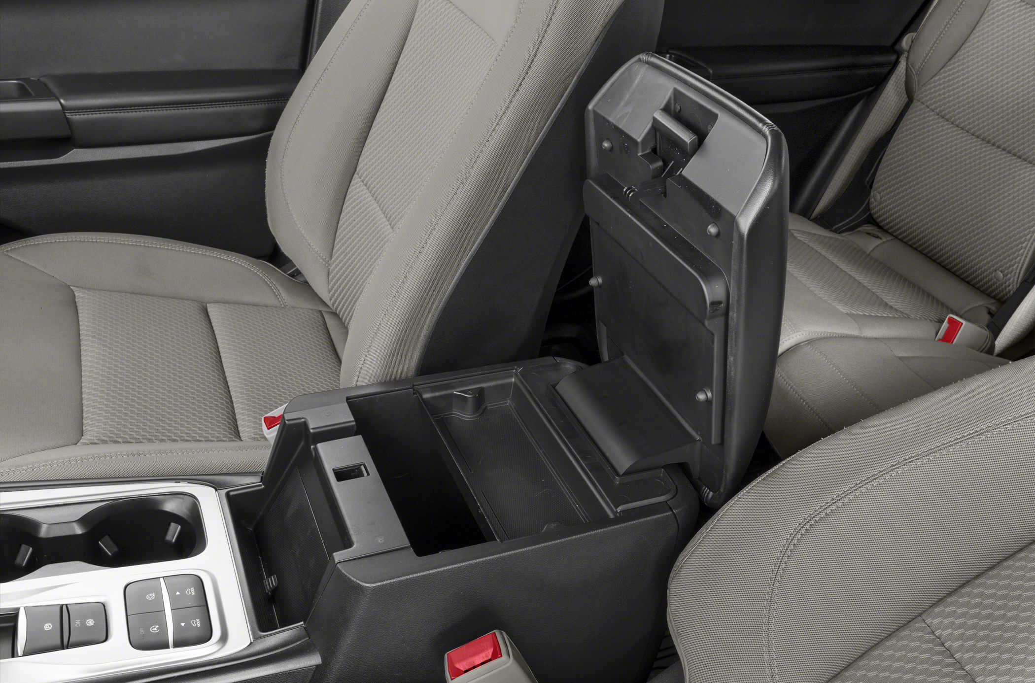 Open center console storage compartment between front seats with folded lid.