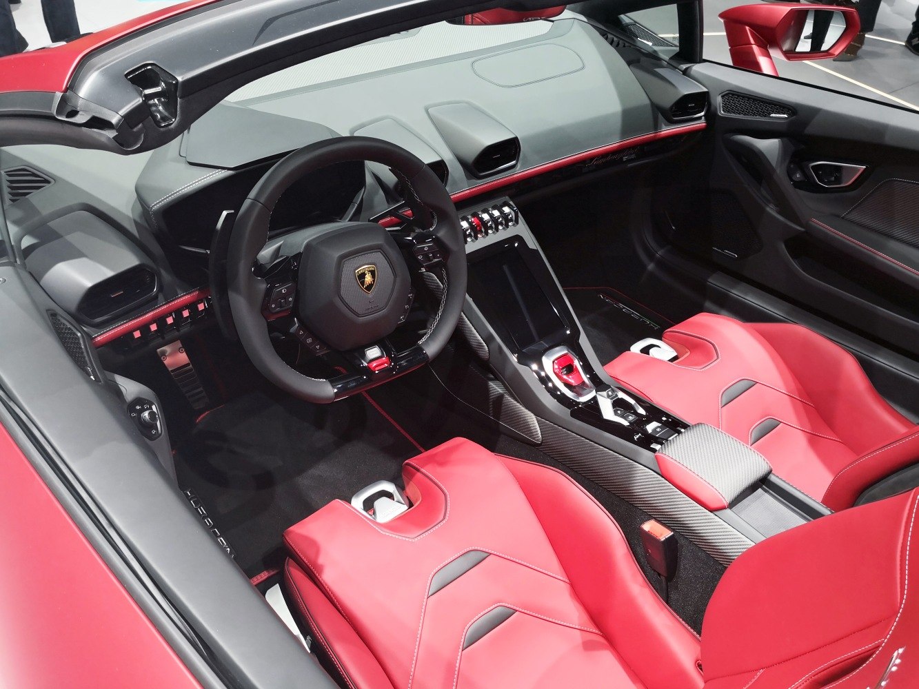 Luxury sports car interior with red leather seats and advanced dashboard