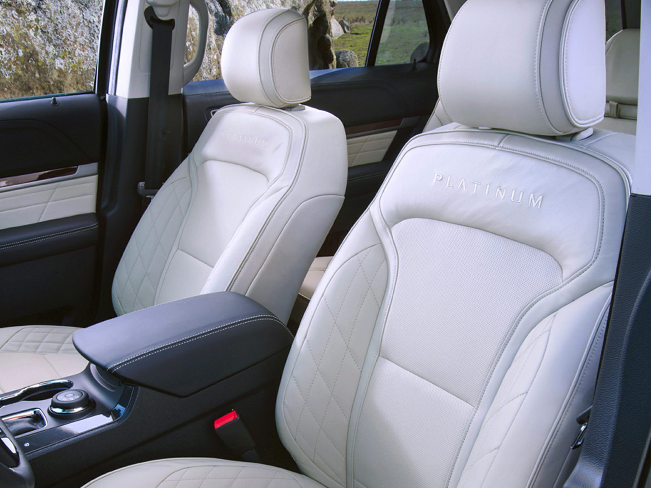 Luxury white leather front seats with diamond stitching and platinum branding