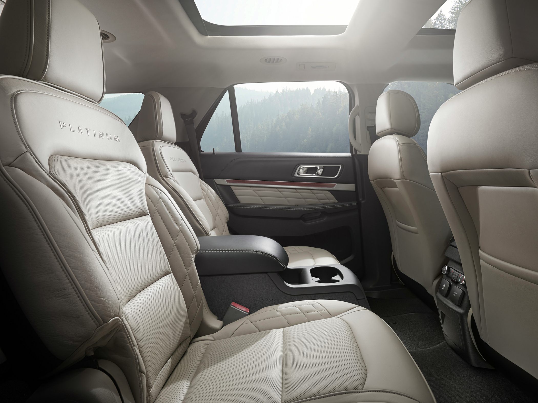 Beige leather seats with stitching and panoramic sunroof.