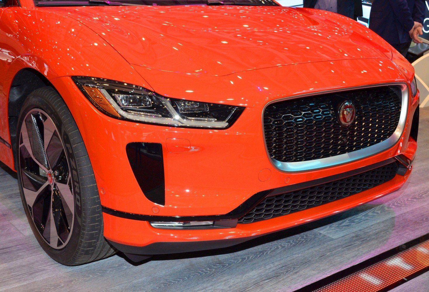 Close-up of car front with LED headlights and honeycomb grille