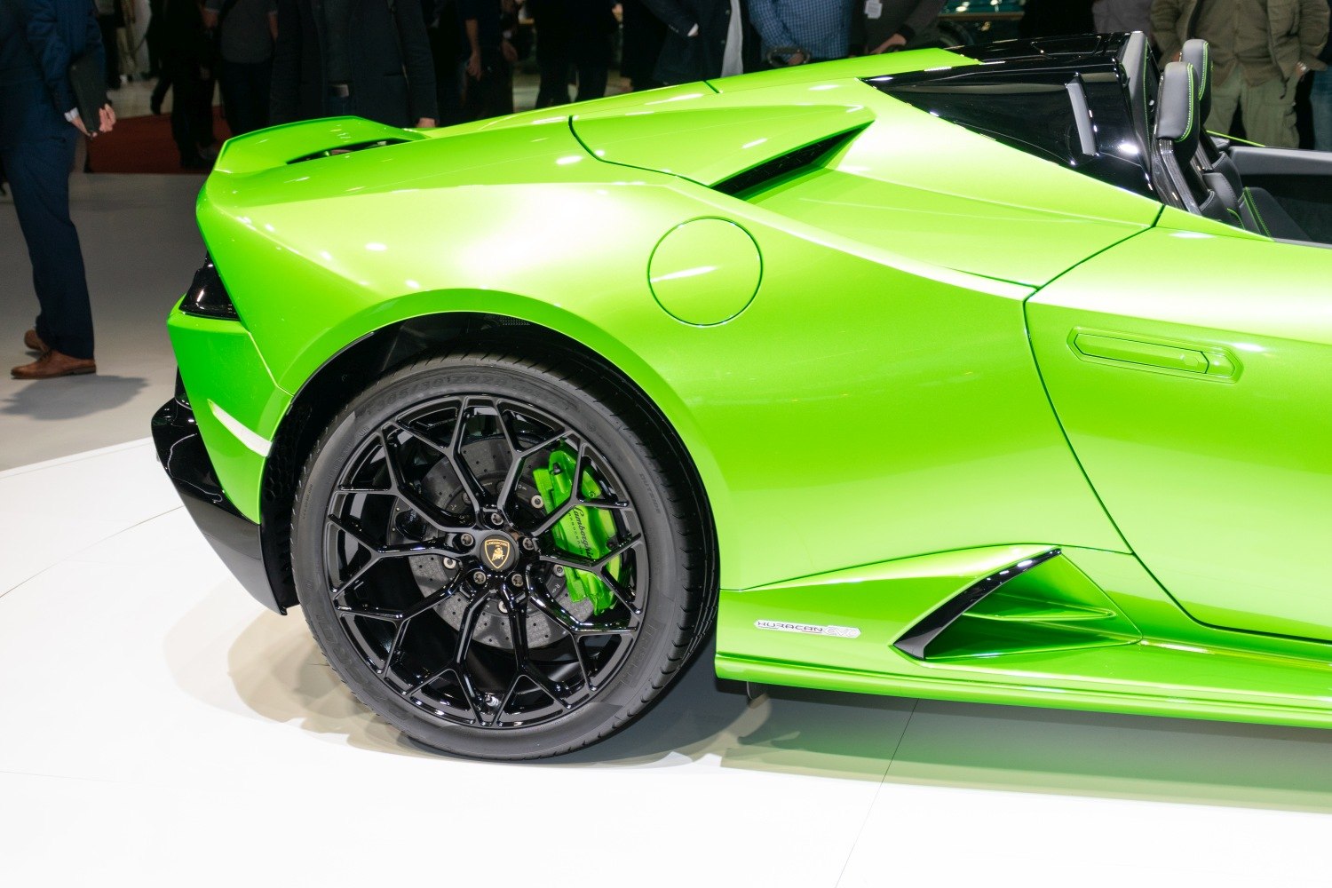 Rear wheel with black rim and green brake caliper, side vent and vibrant green body