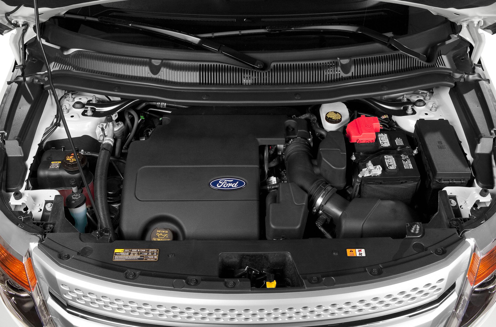 Engine compartment with branded engine cover and battery layout