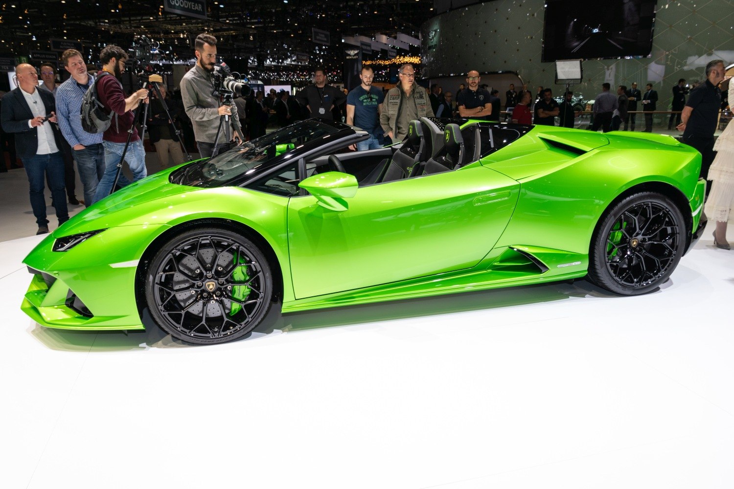 Bright green convertible with black rims in side profile