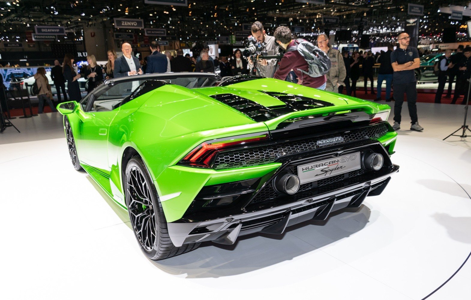 Rear view of green convertible with dual exhaust and honeycomb grille
