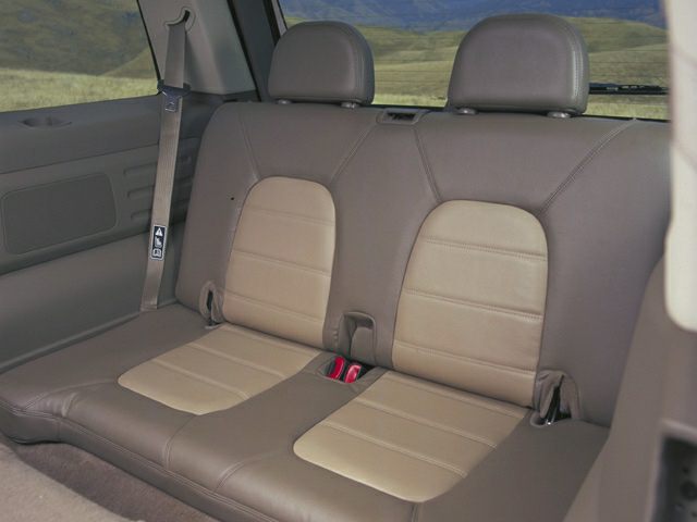 Rear seat with leather upholstery and headrests in two-tone brown.