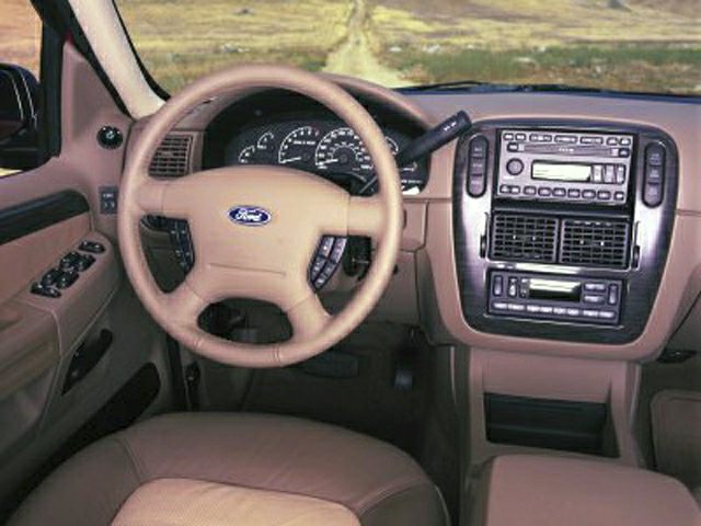Dashboard and steering wheel of a 1995 SUV with tan interior